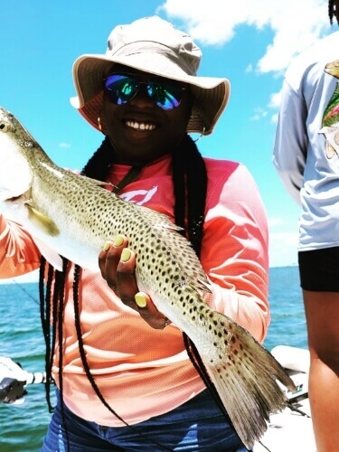 Woman holding a fish caught in Tampa Bay