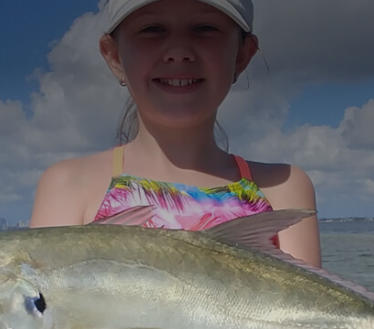 Child holding a fish caught in Tampa Bay Florida