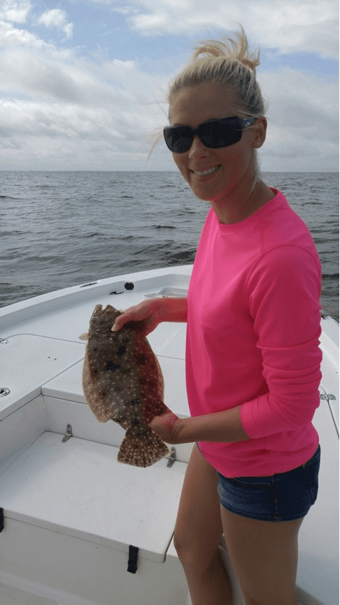 Woman holding a Flounder caught in Tampa Bay