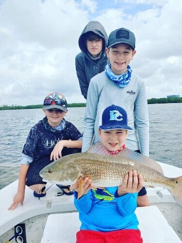 Group of children fishing in Tampa Bay Florida