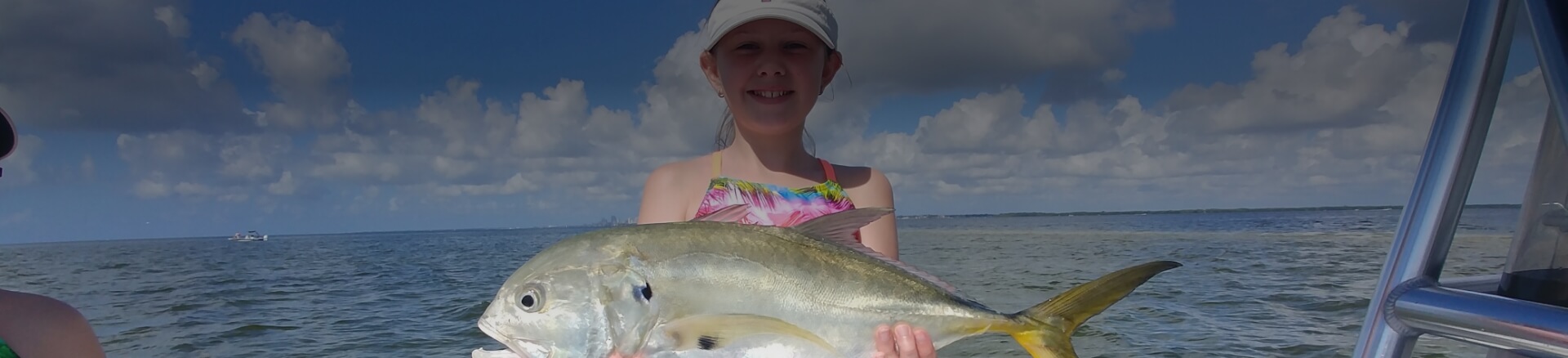 Child holding a fish caught in Tampa Bay Florida
